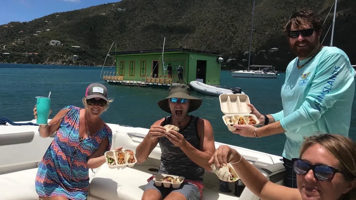 IMG_1927 a group of people sitting at a beach