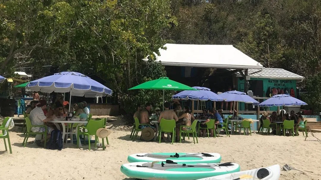 IMG_1929 a group of lawn chairs sitting on top of a sandy beach