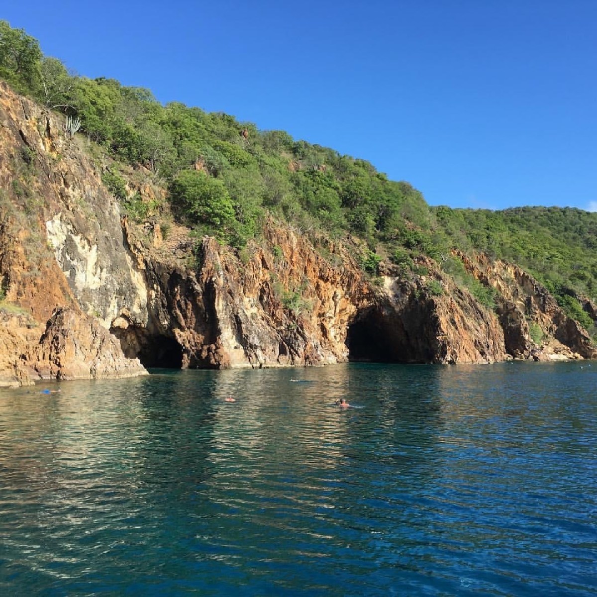 a large body of water with a mountain in the background
