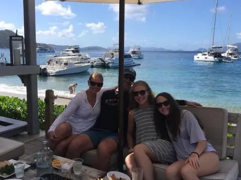 a group of people sitting at a table eating food