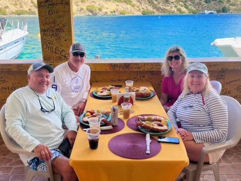 a group of people sitting at a picnic table