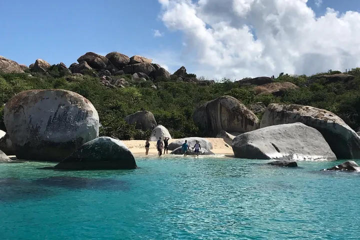 an island in the middle of a body of water with Similan Islands in the background