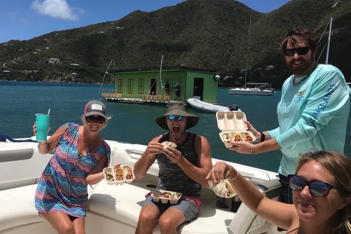 a group of people sitting at a beach