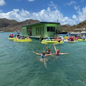 a group of people riding on the back of a boat in the water