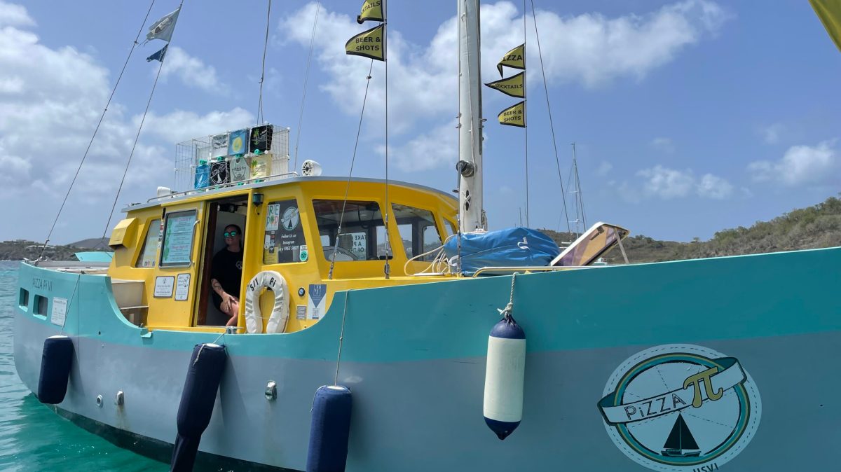 pizza pi a group of people on a boat in the water