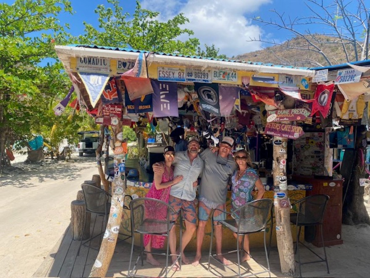 a group of people sitting at a bus stop