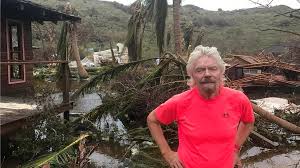 a man standing next to a fence