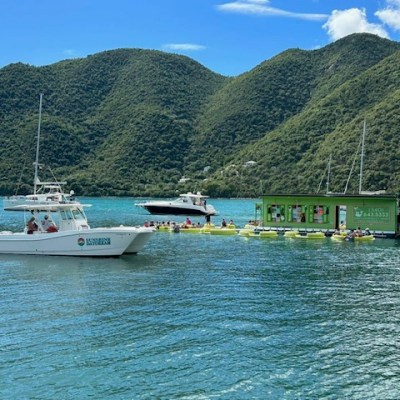 a small boat in a body of water with a mountain in the background