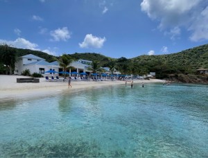 a group of people on a beach near a body of water