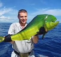 a man holding a fish in the water